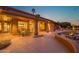 Inviting covered back patio with a water feature and outdoor dining set, perfect for relaxing and entertaining at 15751 W Linksview Dr, Surprise, AZ 85374