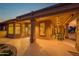 Well-lit covered back patio with a dining set, ideal for outdoor gatherings and comfortable relaxation at 15751 W Linksview Dr, Surprise, AZ 85374