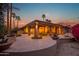 Inviting backyard patio with desert-style landscaping, ambient lighting, and serene outdoor living space at 15751 W Linksview Dr, Surprise, AZ 85374
