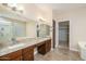 Well lit double sink bathroom with soaking tub, a privacy window and walk in closet at 15751 W Linksview Dr, Surprise, AZ 85374
