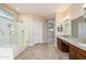 Bright bathroom with a walk-in shower, double vanity, and granite countertops provides a spa-like experience at 15751 W Linksview Dr, Surprise, AZ 85374