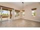 Bright dining area featuring large windows and a sliding glass door to the outdoor patio at 15751 W Linksview Dr, Surprise, AZ 85374
