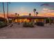 Beautiful backyard exterior view of home, showcasing desert landscaping and stunning sunset colors at 15751 W Linksview Dr, Surprise, AZ 85374