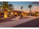 Charming single Gathering home featuring manicured front yard, desert landscaping and a circular driveway at 15751 W Linksview Dr, Surprise, AZ 85374