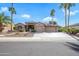 Home with a long driveway leading to a 3-car garage, and lush landscaping at 15751 W Linksview Dr, Surprise, AZ 85374