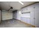 Well-organized garage featuring plenty of storage cabinets, workbench area, and good lighting at 15751 W Linksview Dr, Surprise, AZ 85374