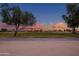 Picturesque view of the golf course at sunset, showcasing lush greenery and surrounding neighborhood at 15751 W Linksview Dr, Surprise, AZ 85374