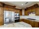 Gourmet kitchen with stainless steel appliances, granite countertops and custom cabinetry at 15751 W Linksview Dr, Surprise, AZ 85374