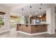 Well-appointed kitchen with a breakfast bar, stainless steel appliances, and ample counter space at 15751 W Linksview Dr, Surprise, AZ 85374