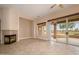 Bright living room with a fireplace and sliding glass doors offering views of the outdoor area at 15751 W Linksview Dr, Surprise, AZ 85374