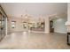 Open-concept living room featuring a breakfast bar that adjoins the kitchen, offering an open flow throughout the home at 15751 W Linksview Dr, Surprise, AZ 85374