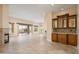 Expansive living room featuring a wet bar, fireplace, and sliding glass doors leading to the outdoor living area at 15751 W Linksview Dr, Surprise, AZ 85374