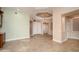 Open-concept living room with a tray ceiling and access to other areas of the home at 15751 W Linksview Dr, Surprise, AZ 85374