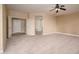 Empty main bedroom showcasing the door leading to the ensuite bath and walk in closet at 15751 W Linksview Dr, Surprise, AZ 85374