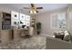 Bright home office with a wooden desk, a chair, and a comfortable seating area at 15751 W Linksview Dr, Surprise, AZ 85374