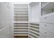 Walk-in closet featuring built-in shelving, drawers, and hanging rods maximizes storage efficiency at 15751 W Linksview Dr, Surprise, AZ 85374