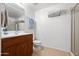 Well-lit bathroom features a wooden vanity, fresh towels, and a shower with glass door at 16 W Encanto Blvd # 616, Phoenix, AZ 85003
