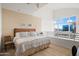 Relaxing bedroom with a ceiling fan features a window view of city buildings and neutral decor at 16 W Encanto Blvd # 616, Phoenix, AZ 85003