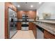 Well-lit kitchen features stainless steel appliances, granite countertops, and wood cabinetry for a modern feel at 16 W Encanto Blvd # 616, Phoenix, AZ 85003