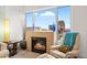 Cozy living room showcases a fireplace, comfortable chair, and a view of the city skyline at 16 W Encanto Blvd # 616, Phoenix, AZ 85003