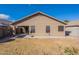 Home's backyard with covered patio, privacy walls and green grass at 16167 W Cottonwood St, Surprise, AZ 85374