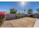 A backyard featuring tall privacy walls, some green trees, and a gazebo at 16167 W Cottonwood St, Surprise, AZ 85374