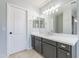 Stylish bathroom with gray vanity, quartz countertop, updated lighting, and white door at 16167 W Cottonwood St, Surprise, AZ 85374