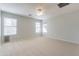 Spacious bedroom has multiple windows for natural light and a ceiling fan for added comfort at 16167 W Cottonwood St, Surprise, AZ 85374