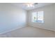 Bright bedroom with a window, neutral carpet, and ceiling fan at 16167 W Cottonwood St, Surprise, AZ 85374
