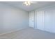 A bright bedroom features a closet for storage and neutral carpet at 16167 W Cottonwood St, Surprise, AZ 85374
