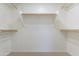 Spacious walk-in closet featuring white shelves and racks for optimal storage organization at 16167 W Cottonwood St, Surprise, AZ 85374