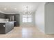 Bright dining area features modern chandelier and window with lots of natural light next to the kitchen area at 16167 W Cottonwood St, Surprise, AZ 85374