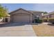 Charming home featuring a two-car garage, neutral tones, and a well-maintained front yard at 16167 W Cottonwood St, Surprise, AZ 85374