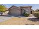 Attractive home with a two-car garage, desert landscaping, and a tidy, well-kept lawn at 16167 W Cottonwood St, Surprise, AZ 85374