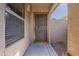 A cozy home entry showcases a secure screen door and adjacent window at 16167 W Cottonwood St, Surprise, AZ 85374