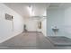 A well-lit garage featuring a water heater, storage racks, and utility sink at 16167 W Cottonwood St, Surprise, AZ 85374