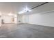 Spacious two car garage with white walls, overhead lighting and concrete floors at 16167 W Cottonwood St, Surprise, AZ 85374