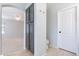 Hallway area featuring tile flooring, built in cabinets, access to another room and bathroom at 16167 W Cottonwood St, Surprise, AZ 85374