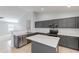 The kitchen includes stainless appliances, gray cabinets, and a center island with white countertop at 16167 W Cottonwood St, Surprise, AZ 85374