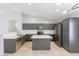 Beautiful kitchen features gray cabinets, stainless steel appliances, a center island and white subway tile backsplash at 16167 W Cottonwood St, Surprise, AZ 85374