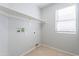 Laundry room with neutral color palette and a shelf above for storage at 16167 W Cottonwood St, Surprise, AZ 85374