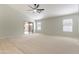 An airy living room featuring a sliding glass door, neutral carpet, and abundant natural light at 16167 W Cottonwood St, Surprise, AZ 85374