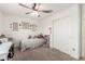 Well-lit bedroom with ceiling fan, desk, and neutral tones, ideal for relaxation and productivity at 18449 E Eloisa Dr, Gold Canyon, AZ 85118