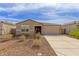 Charming single-story home with a neutral color scheme and a well-maintained front yard at 18449 E Eloisa Dr, Gold Canyon, AZ 85118