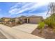 Inviting single-story home featuring a well-manicured front yard and a two car garage at 18449 E Eloisa Dr, Gold Canyon, AZ 85118