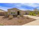 Inviting single-story home featuring a well-manicured front yard and a two car garage at 18449 E Eloisa Dr, Gold Canyon, AZ 85118