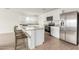 Bright kitchen featuring stainless appliances, stone countertops, and an island with bar stool seating at 18449 E Eloisa Dr, Gold Canyon, AZ 85118