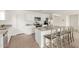 Modern kitchen with stainless steel appliances, white cabinetry, and granite countertops with a breakfast bar at 18449 E Eloisa Dr, Gold Canyon, AZ 85118