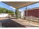 Paver patio with lounge chairs, desert landscaping, and a charming white picket fence at 201 S Greenfield Rd # 152, Mesa, AZ 85206