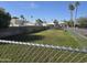 Community backyard featuring green grass with a chain link fence and perimeter block wall at 201 S Greenfield Rd # 152, Mesa, AZ 85206